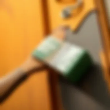 Brush Application Technique A close-up of a brush applying paint to a cabinet door